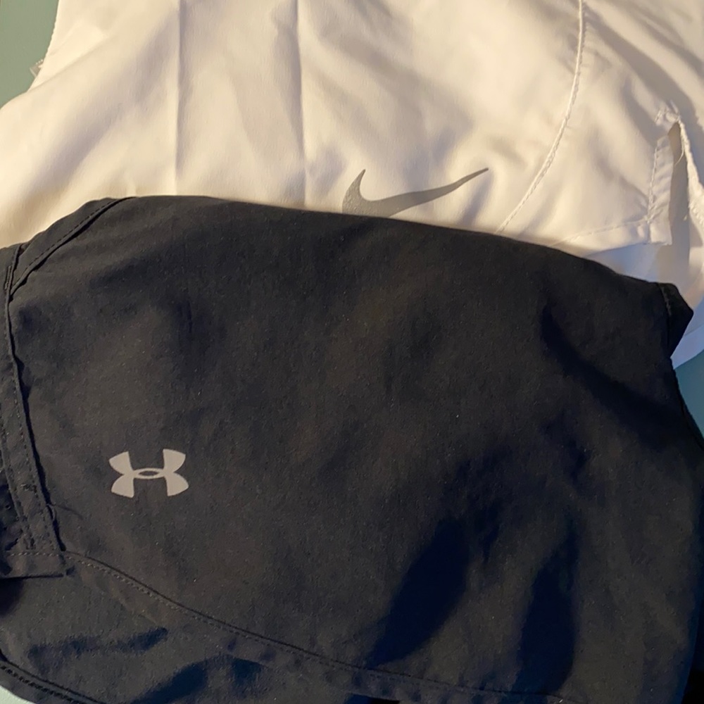 Black UA and Nike running shorts
